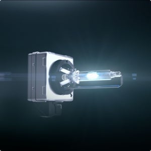 Close-up on a Xenon headlight lit up against a darkened background.